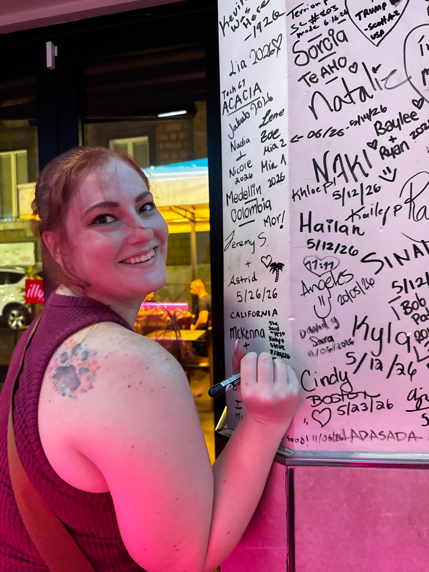 A guest adding her signature among names from California, Boston and Colombia